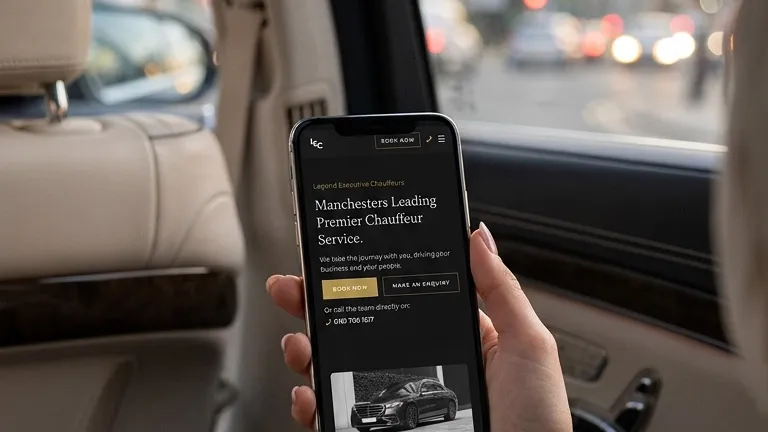 Legend Executive Chauffeurs mobile website on a phone in the back of an executive car